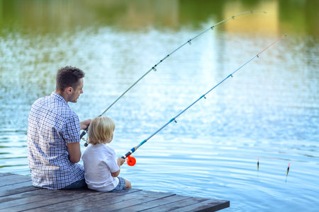 dad and son fishing at lake